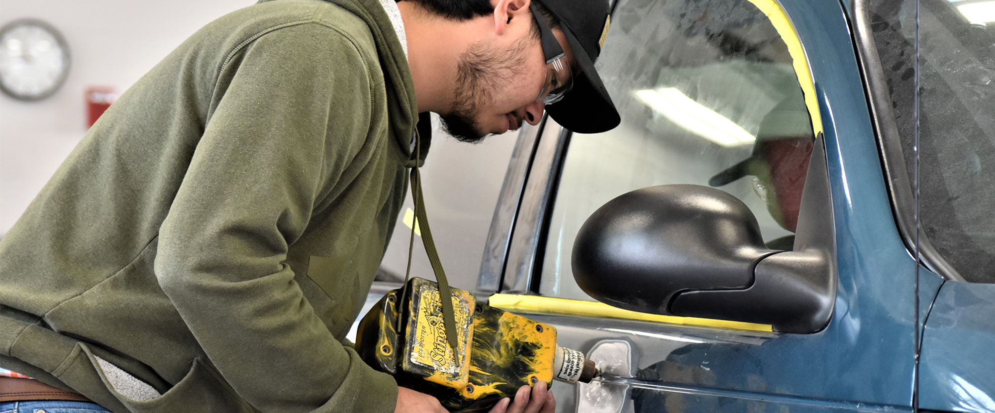Male student working on car
