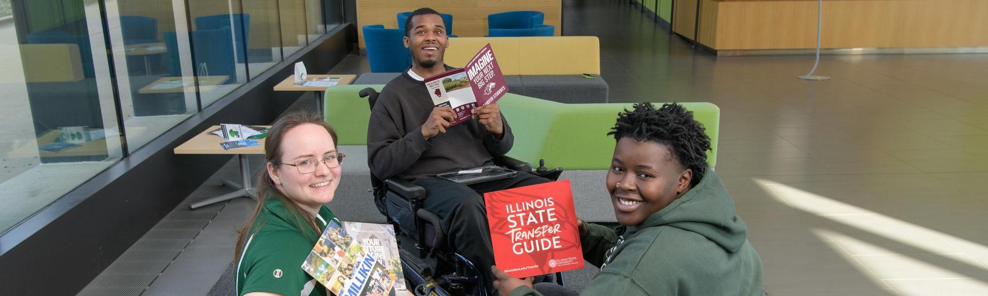 Three students looking at transfer guides