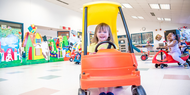 toddler in toy car