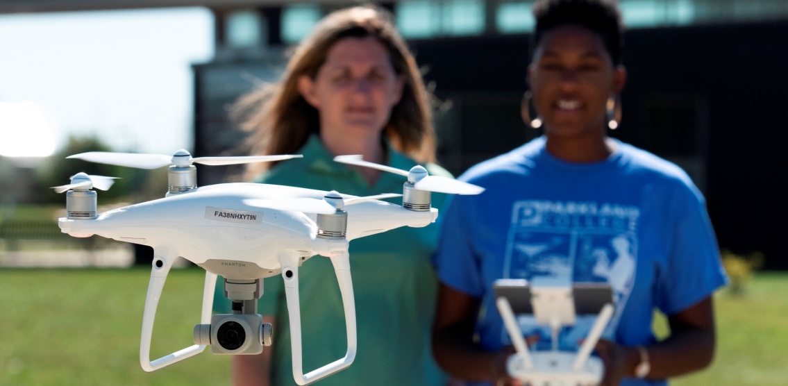 Two women piloting drone