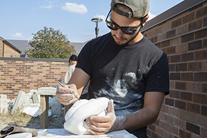 Sculpture student outdoors