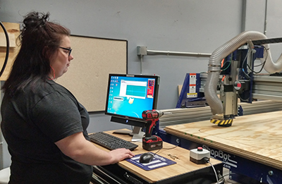 student using lathe in theatre scene shop