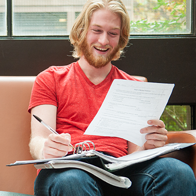man looking at paper and smiling