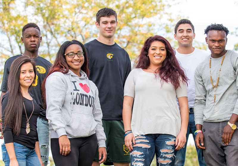 seven students of various ethnicities posing outdoors