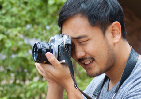 Male student holding camera