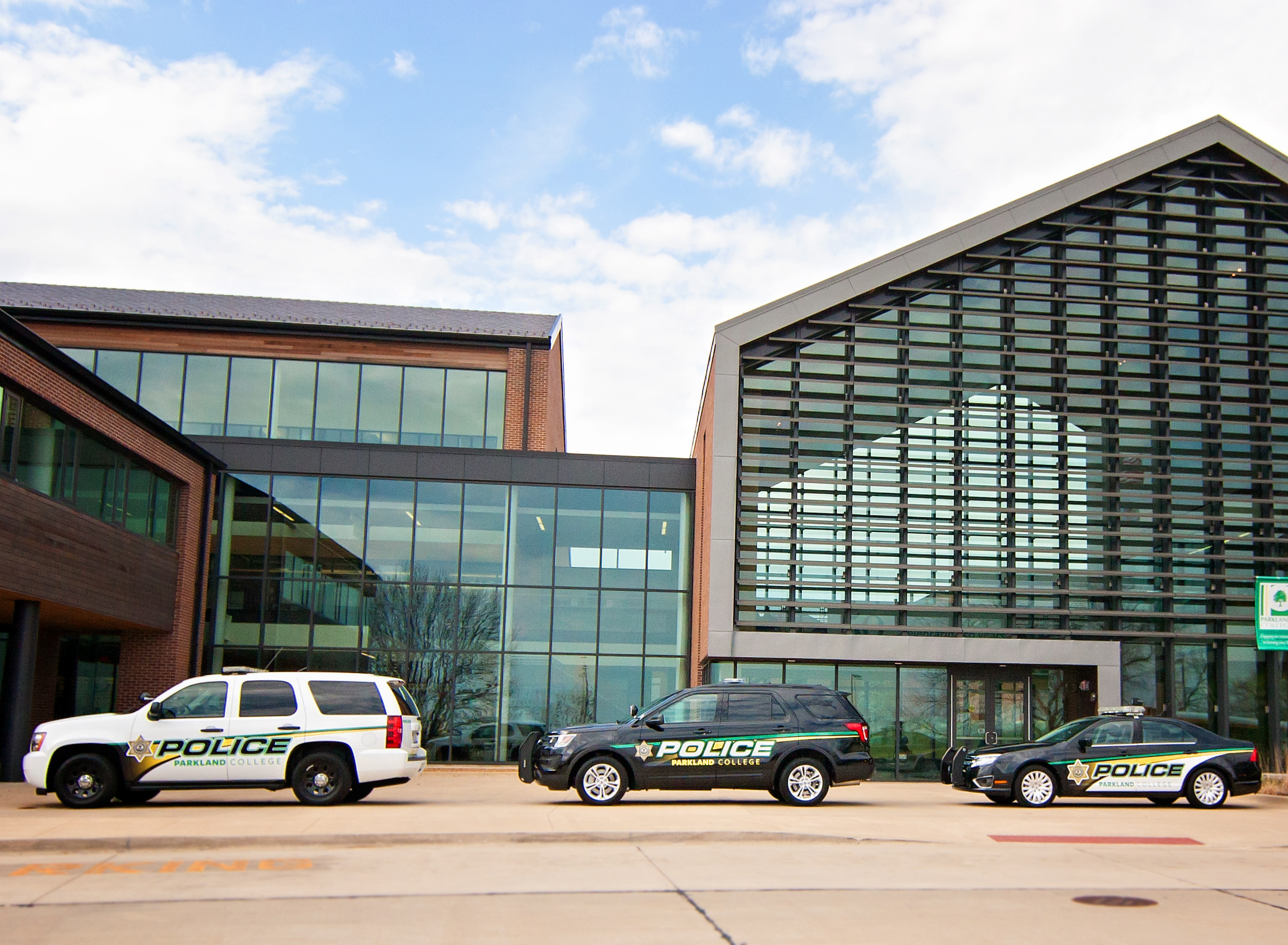 campus safety vehicles in front of campus building